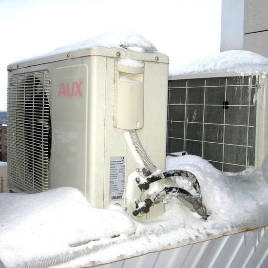 The air conditioner unit is covered in ice