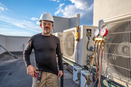Technician working with air conditioning unit