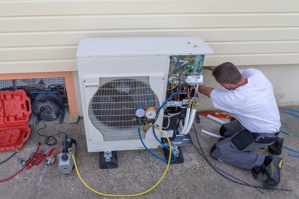Technician repairing HVAC system outside the house