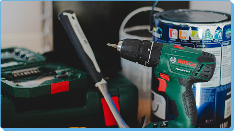 Bosch drill with tools and paint can.