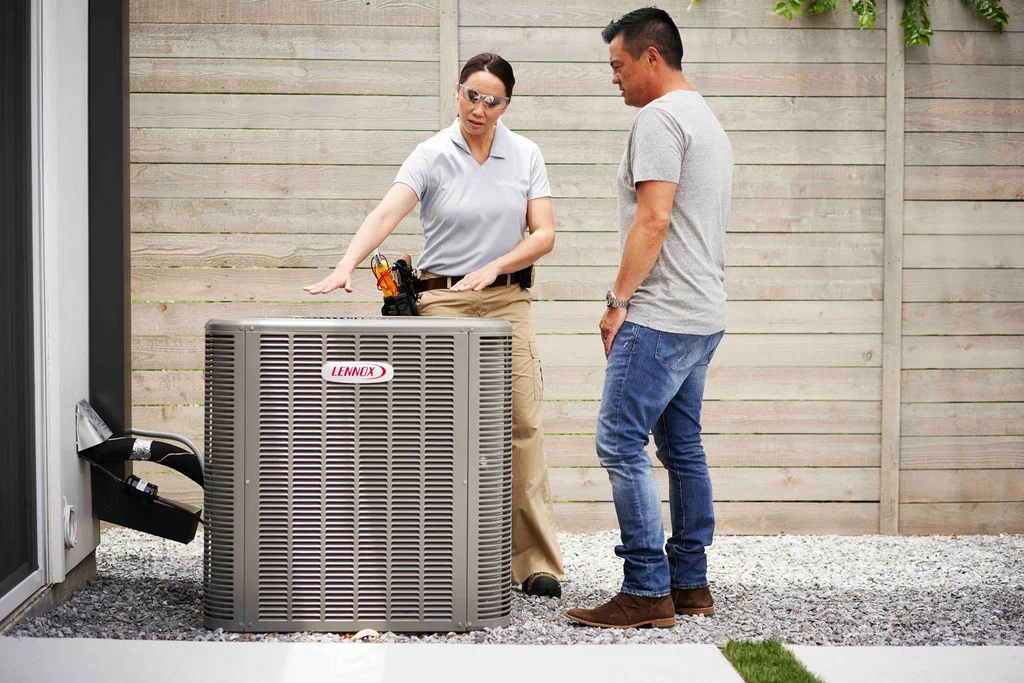 Technician explaining air conditioning system to customer
