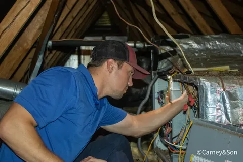 A technician is working on a furnace system