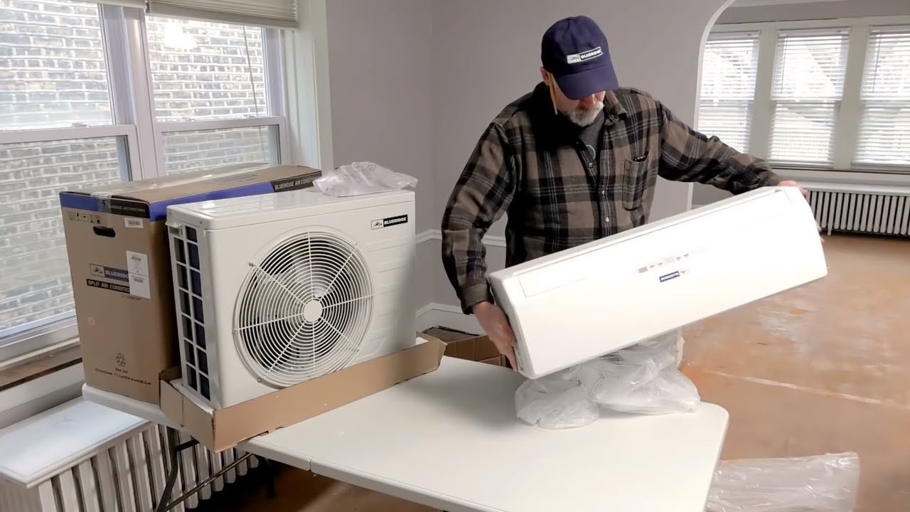 An air conditioner unit is being unpacked.