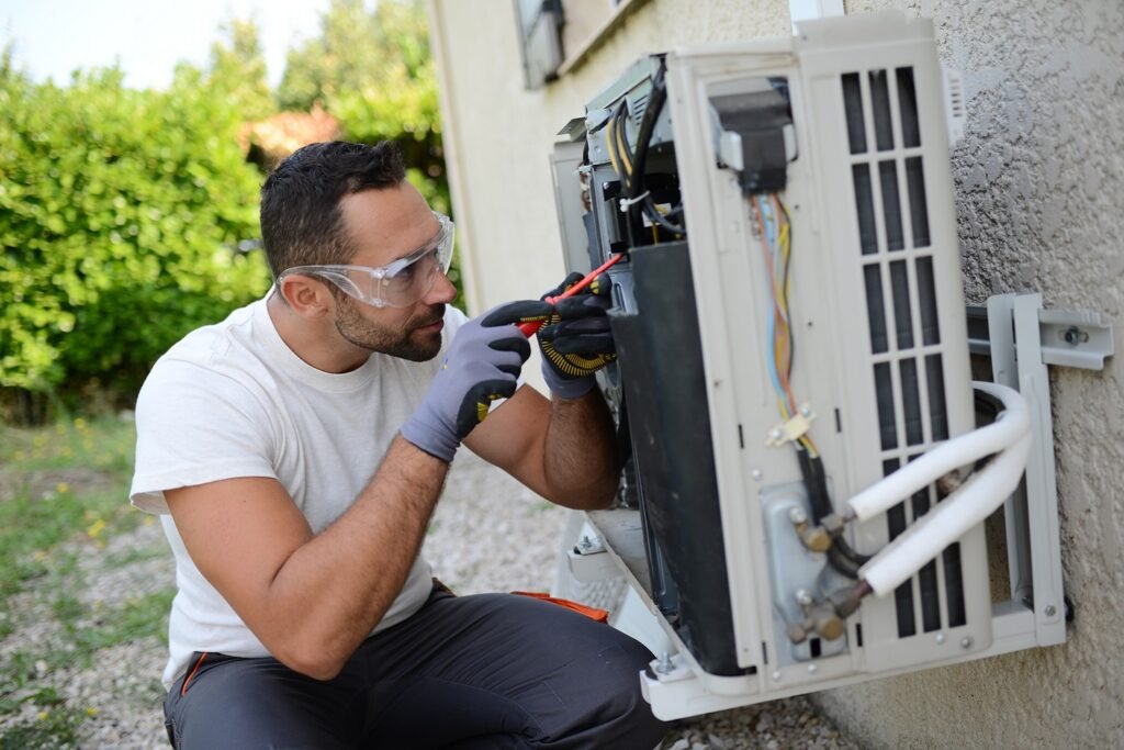 Technician working on outdoor air conditioning unit