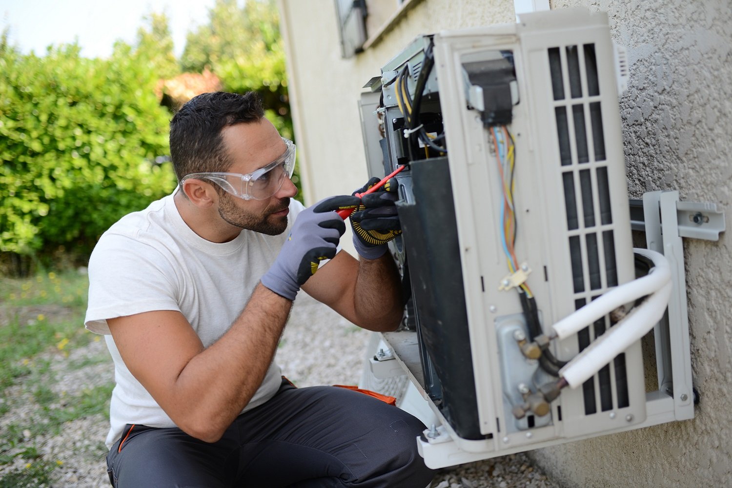 Technician working on outdoor air conditioning unit