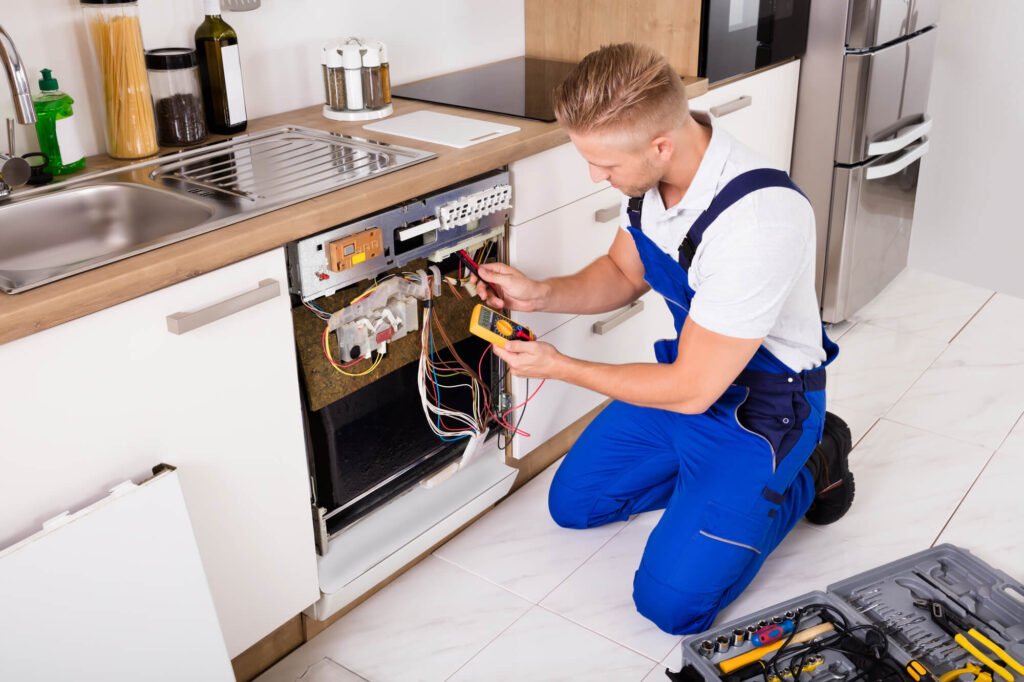 Technician repairing dishwasher using a multimeter