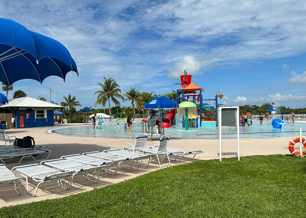 Water park with slides and umbrellas on a sunny day